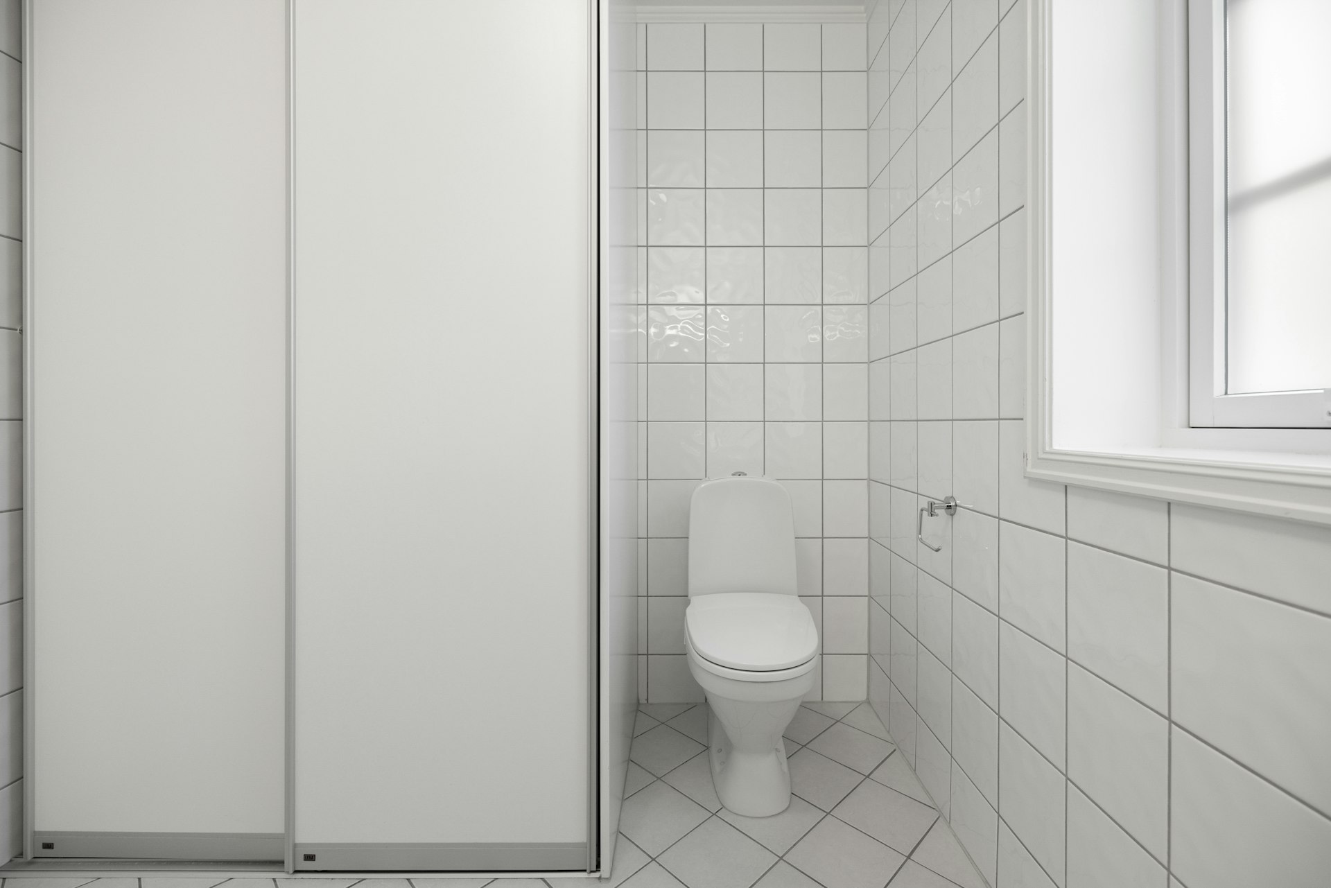 A bathroom with a toilet and a shower stall